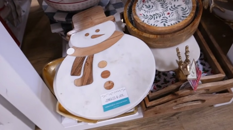 A marble snowman serving board with wood details