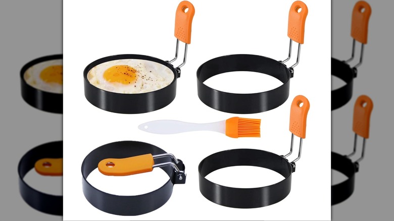 A set of four Egg Rings and an oil brush on a white background