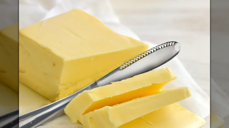 Stainless Steel Butter Spreader cutting into a block of butter