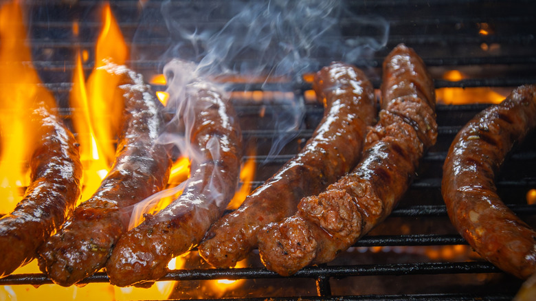 Several merguez sausages on a grill