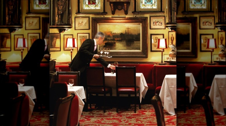 waiter setting table at Rules Restaurant