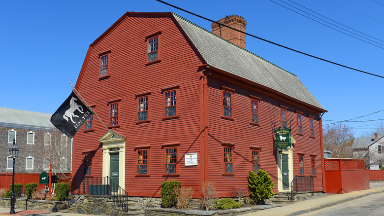 Red colonial building with horse flag