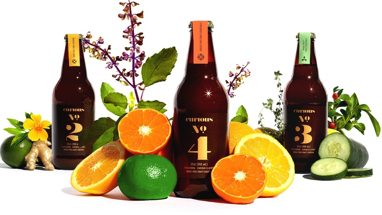 Bottles of Curious Elixirs & fruit