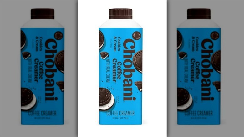 Chobani cookies and cream creamer in a teal blue bottle with dark brown lid on white background