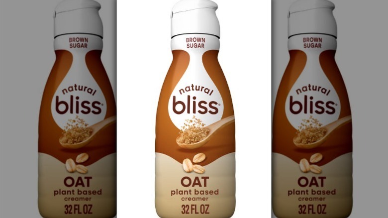 Natural Bliss brown sugar creamer in a white, brown, and beige bottle on white background