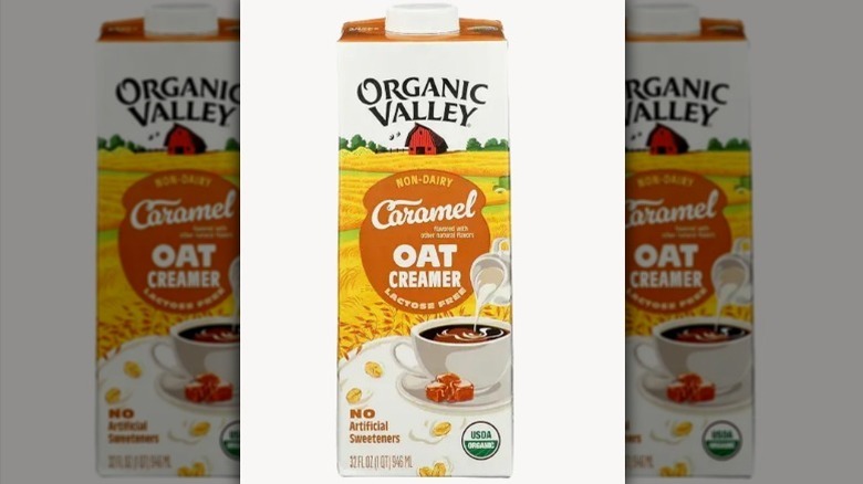 Organic Valley caramel oat creamer in a white, yellow, and tan carton on white background