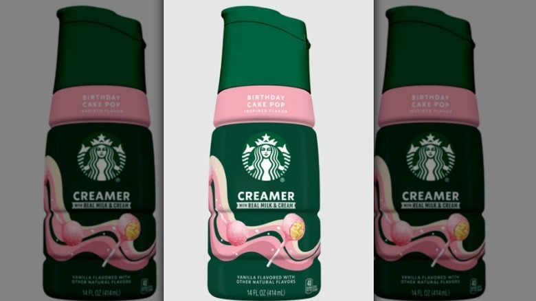 Starbucks birthday cake pop creamer in a baby pink and forest green bottle on white background