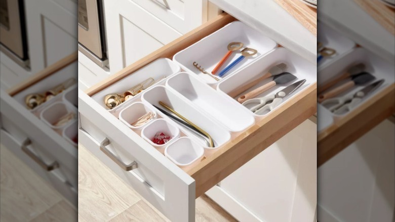 Plastic drawer organizer set in drawer