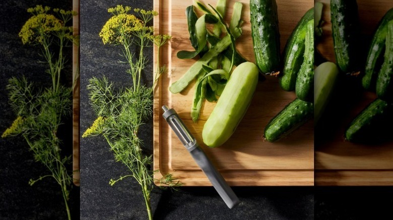 Figment swivel peeler on wood board with produce