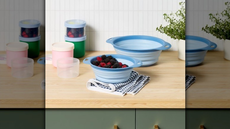 Collapsible colander set on counter with berries