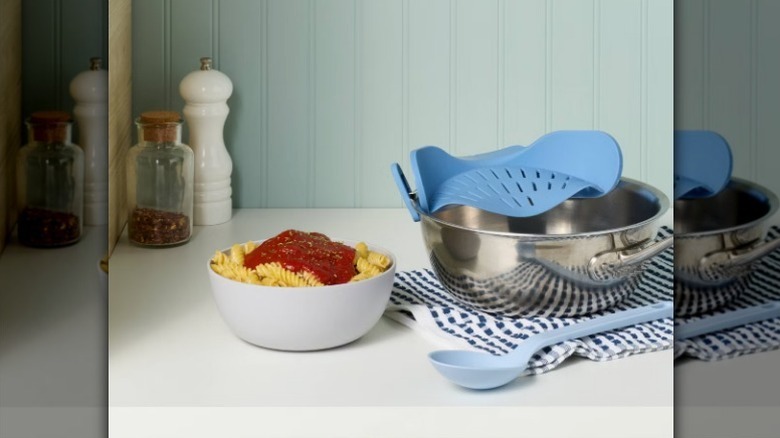 Clip on strainer on metal bowl with pasta