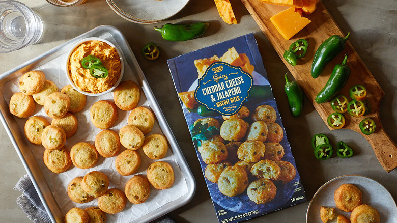 Cheddar jalapeño biscuits on baking sheet with dip and the box nearby.