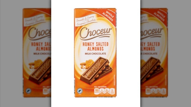 Honey salted almond chocolate bar on white background