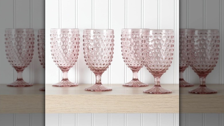 Four pink goblets on shelf