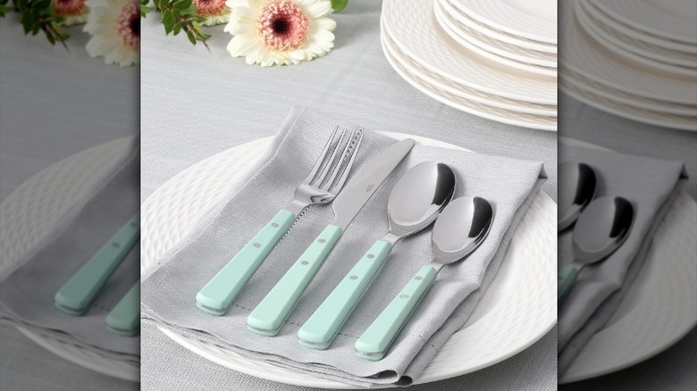 Four-piece cutlery on napkin and plate
