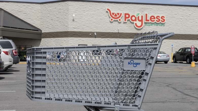 Kroger shopping basket in front of a Pay Less Super Market