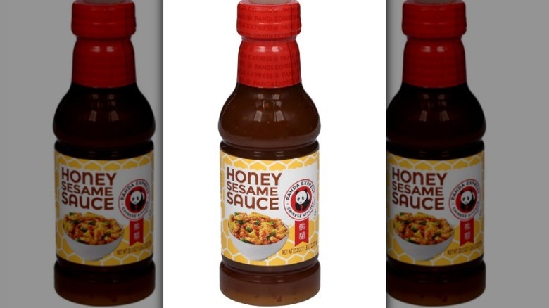 Panda Express honey sesame sauce with a red lid on white background