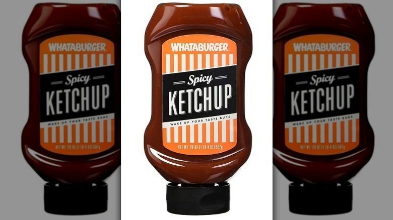 Whataburger spicy ketchup with an orange, white and black label on white background