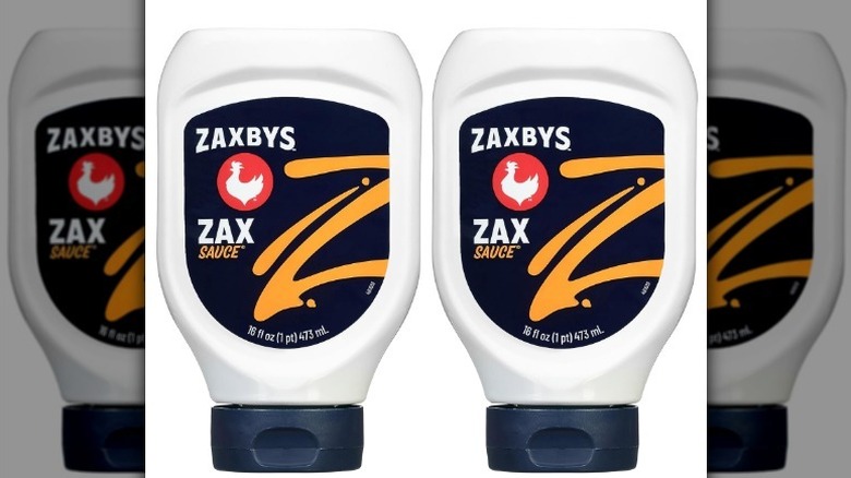 Zaxbys zax sauce with a black, orange, red, and white label on white background