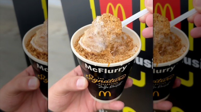 A hand holding a tres leches McFlurry in a cup
