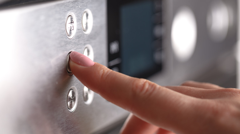 pushing button on oven