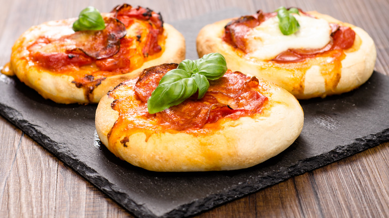 mini pizzas on square stone