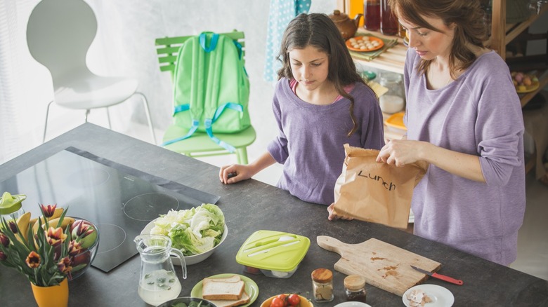 mother and daughter packing lunch