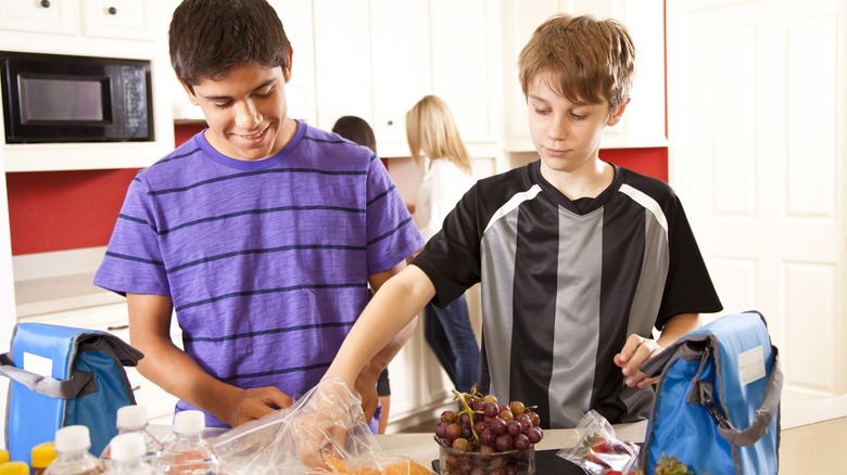 two boys packing school lunch