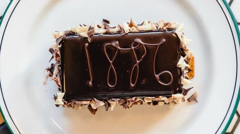 1886 chocolate cake slice on plate