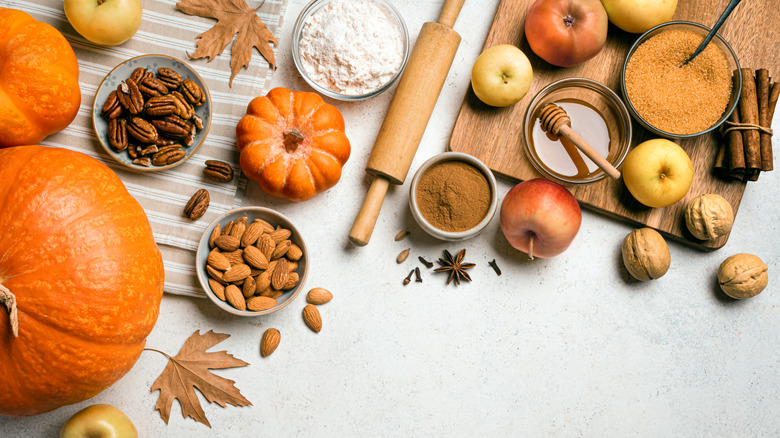 An overhead view of fall baking ingredients and tools on a countertop
