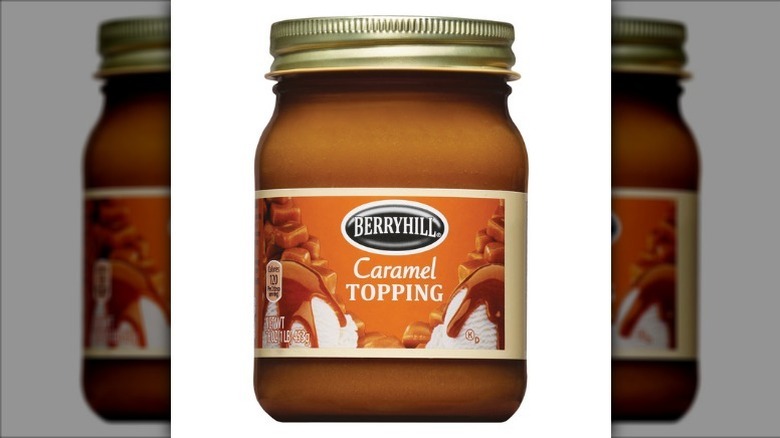 Berryhill caramel topping in a glass jar with a gold lid on a white background.