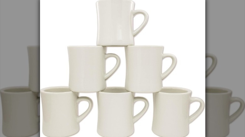 Stack of diner coffee mug against white background.