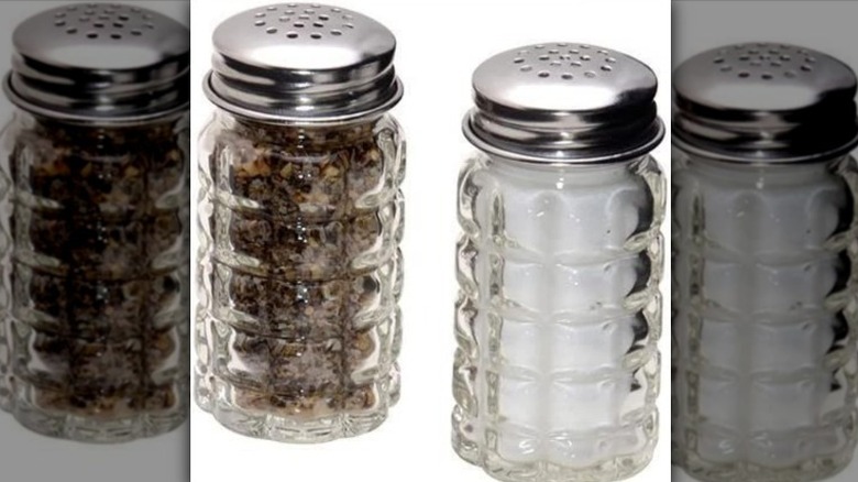 Salt and pepper shaker against white background.
