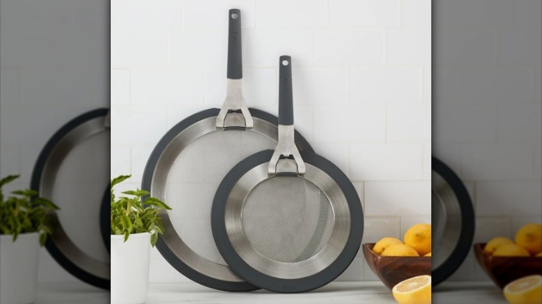 Splatter guard set rests against the wall