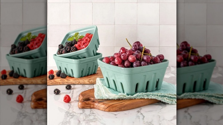 Green berry baskets on counter with fruit