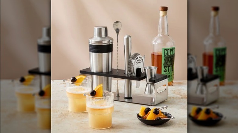 Bar tool set on counter with drinks and bottle