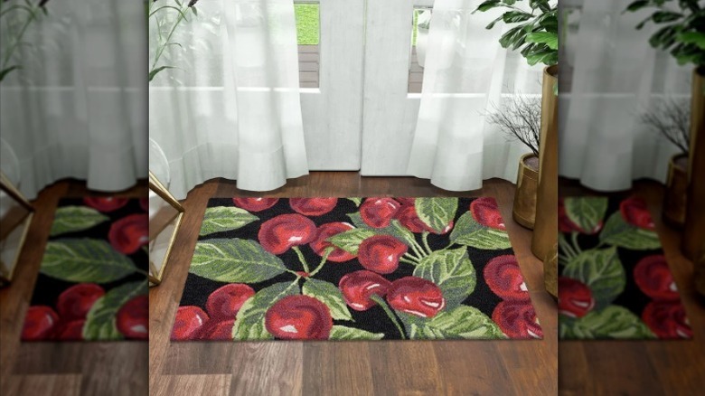 Cherry themed spring accent rug on floor next to doors