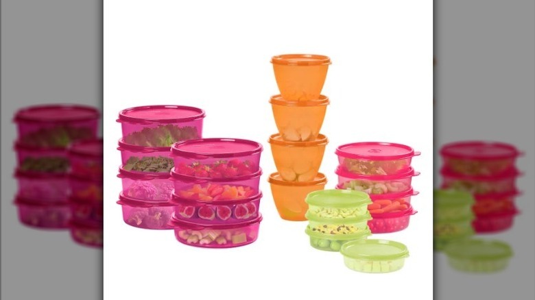 Tupperware set with food on white background