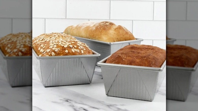 Loaf pan set with baked bread on counter