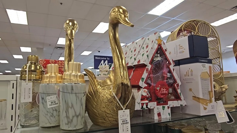 Gold champagne swan on a HomeGoods shelf, surrounded by other products