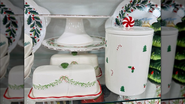 Holly-decorated butter, cake, and cookie dishes on a HomeGoods shelf