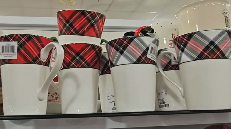 Plaid-rimmed coffee mugs on a HomeGoods shelf