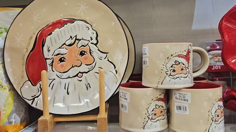 Santa plates and mugs arranged together on a HomeGoods shelf