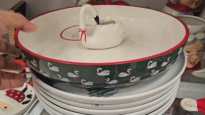 Hand reaching for the swan party bowl with toothpick holder