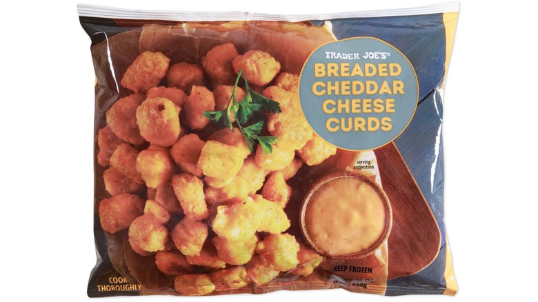 Bag of Trader Joe's Breaded Cheddar Cheese Curds against white background.