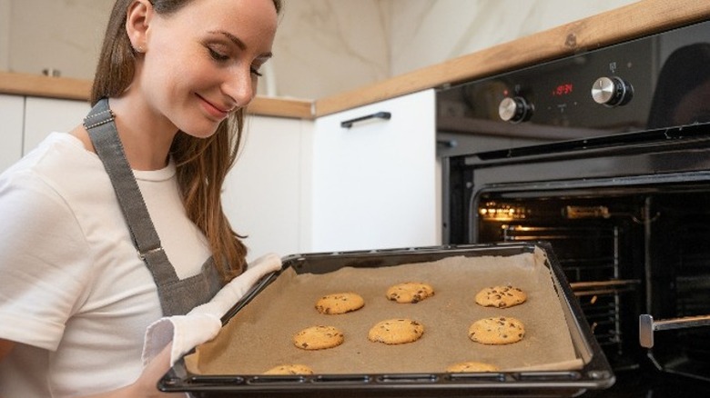 woman holding tray of cookies