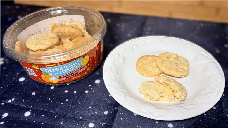 Orange cream cookies on plate next to product package