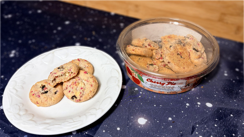 Cherry pie cookies on plate next to product package