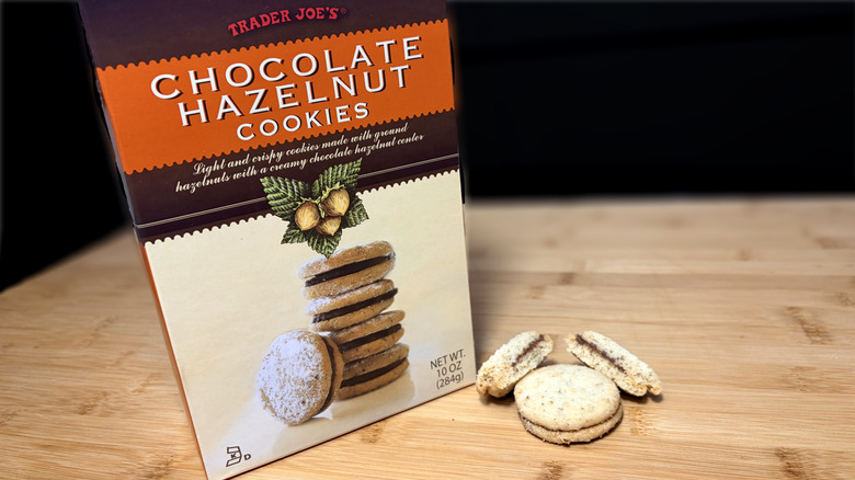 Chocolate hazelnut cookies on cutting board next to product box