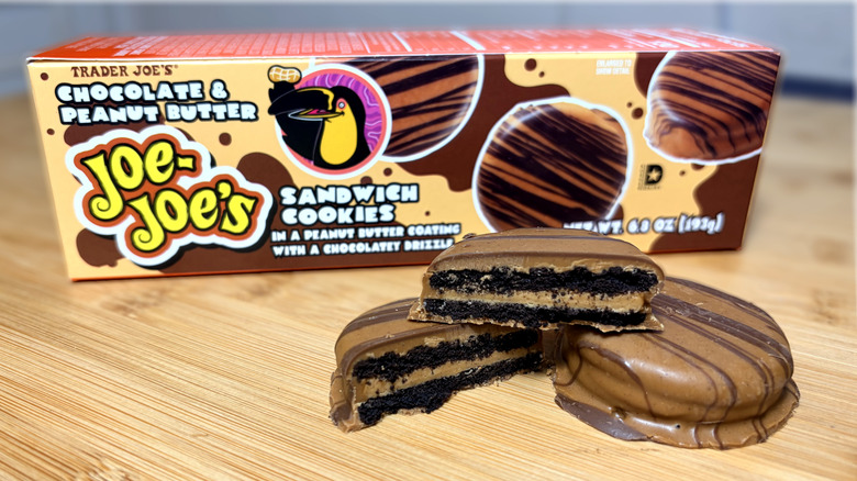 Chocolate covered sandwich cookies on cutting board next to product box